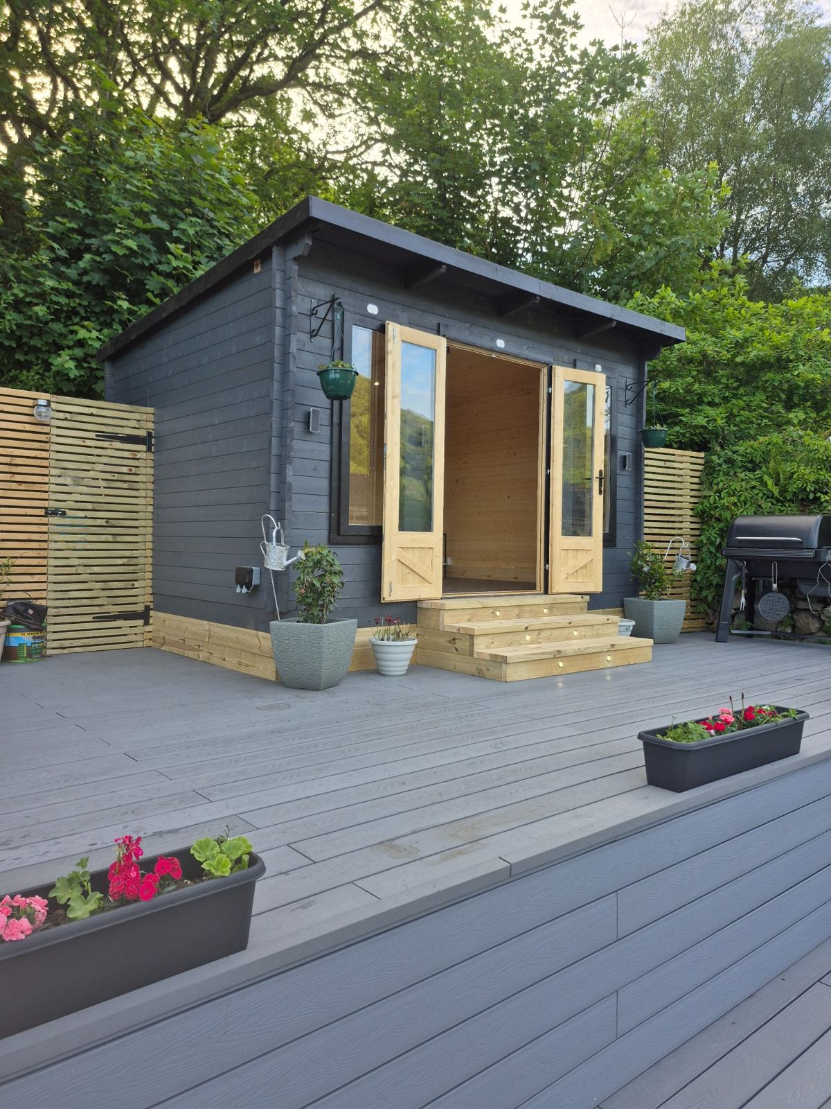 Finished garden room project by SRG - Limited; composite decking shown for context only