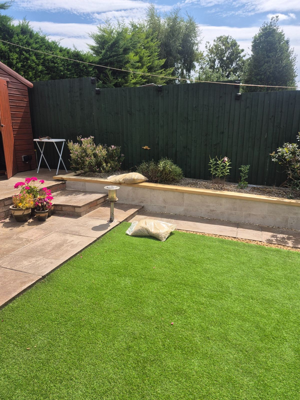 Tiled garden wall with treated timber capping completed by SRG - Limited